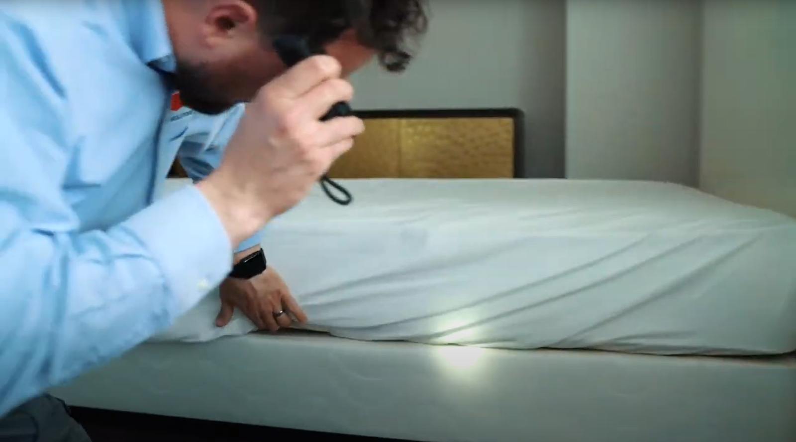 Pest Control in Encinitas technician inspecting a mattress for hidden pests during a home evaluation.